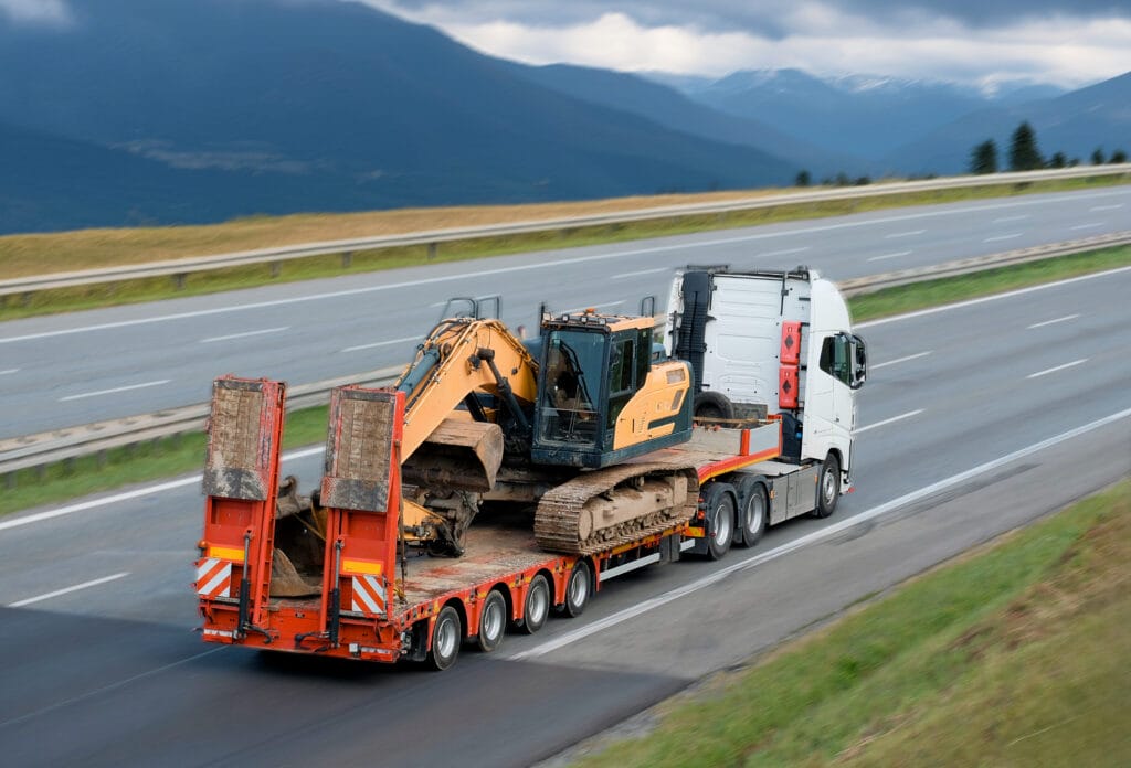 Heavy Machinery Equipment Transportation On Flatbed Trailer