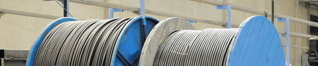 cable wound on large industrial reels inside a manufacturing and logistics facility